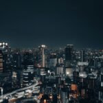 A captivating nighttime cityscape showcasing a vibrant urban skyline with illuminated buildings.