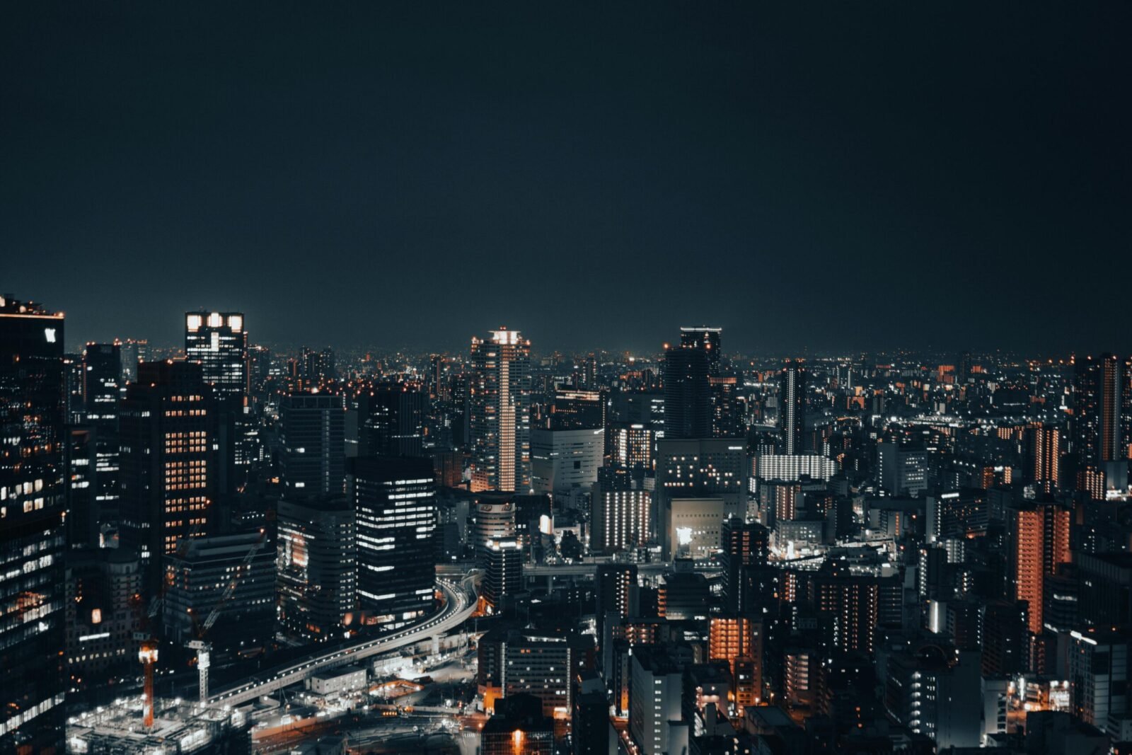 A captivating nighttime cityscape showcasing a vibrant urban skyline with illuminated buildings.